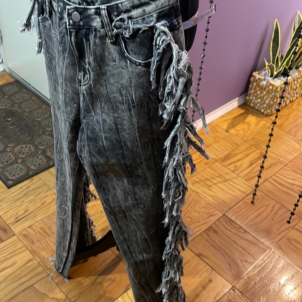 Grey tie-dye denim jeans with tassel fringes alongside dress up or down